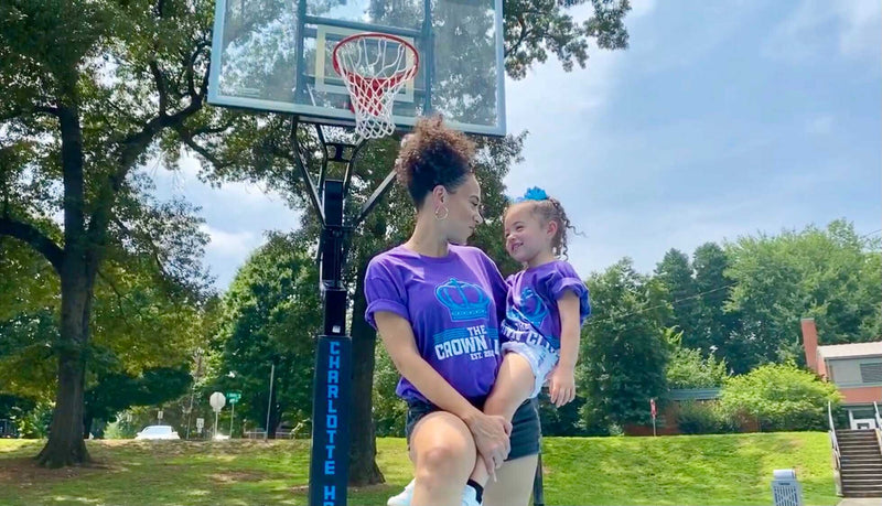 A Crown Club family, parent and kid in crown shirts