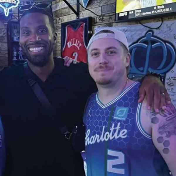 Evan Kent in a Charlotte jersey with his best friend Coach Lee